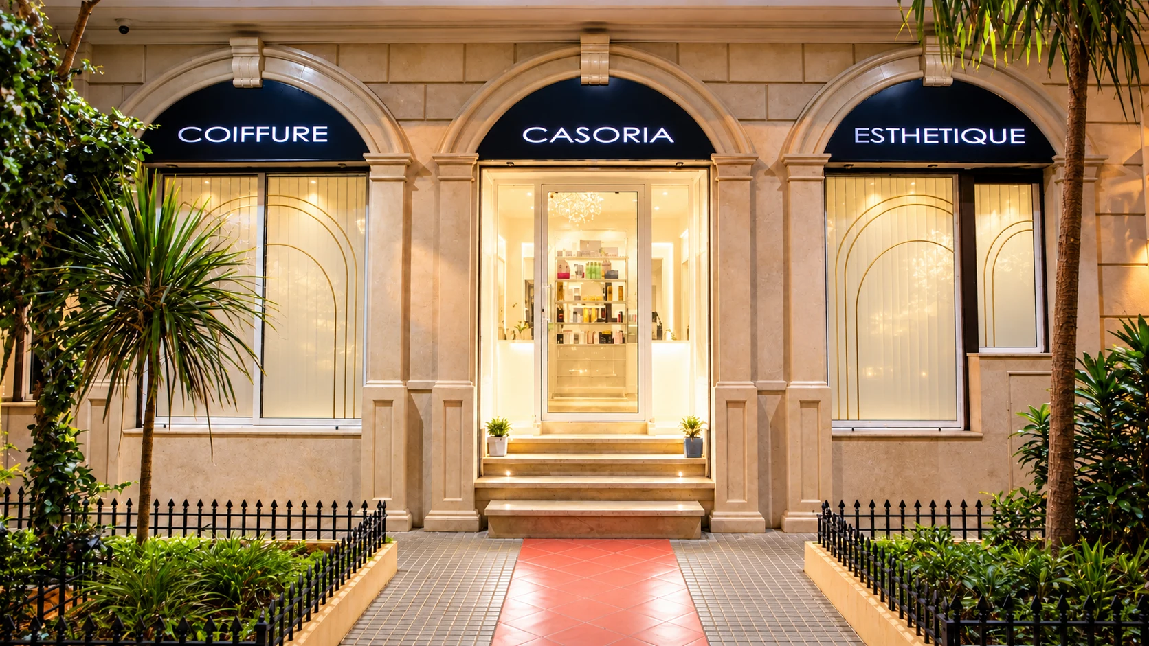 Façade du Salon Casoria : trois arches éclairées, enseignes Coiffure, Casoria et Esthétique, et entrée centrale